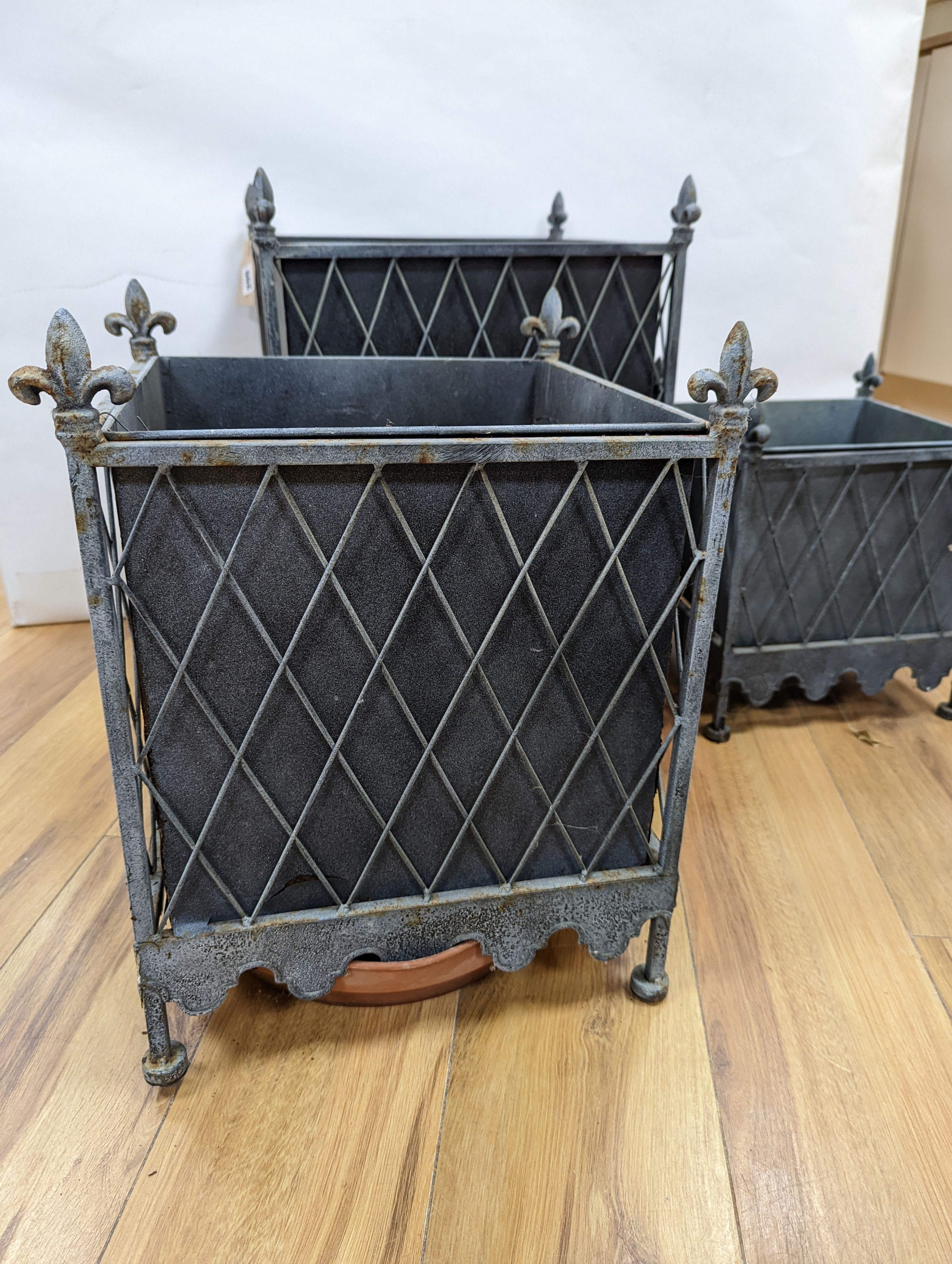 A graduated set of three zinc plated iron jardinieres, largest 41 cm wide, 51. 5 cm high